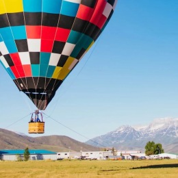 an open field with a hot air balloon