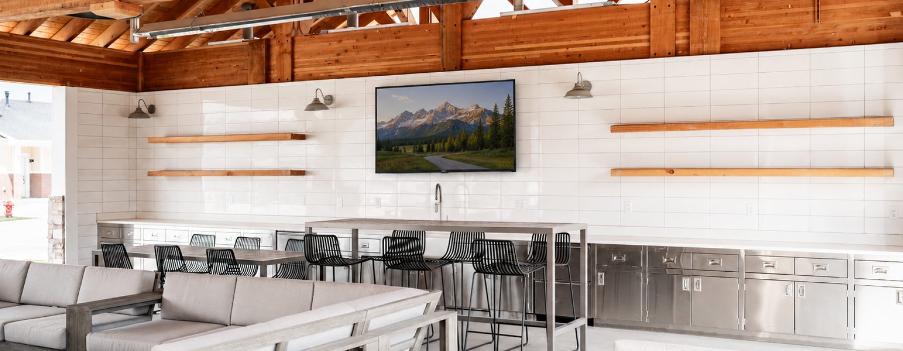 Outdoor community clubhouse with large tv, and outdoor kitchen in Heber Valley UT 