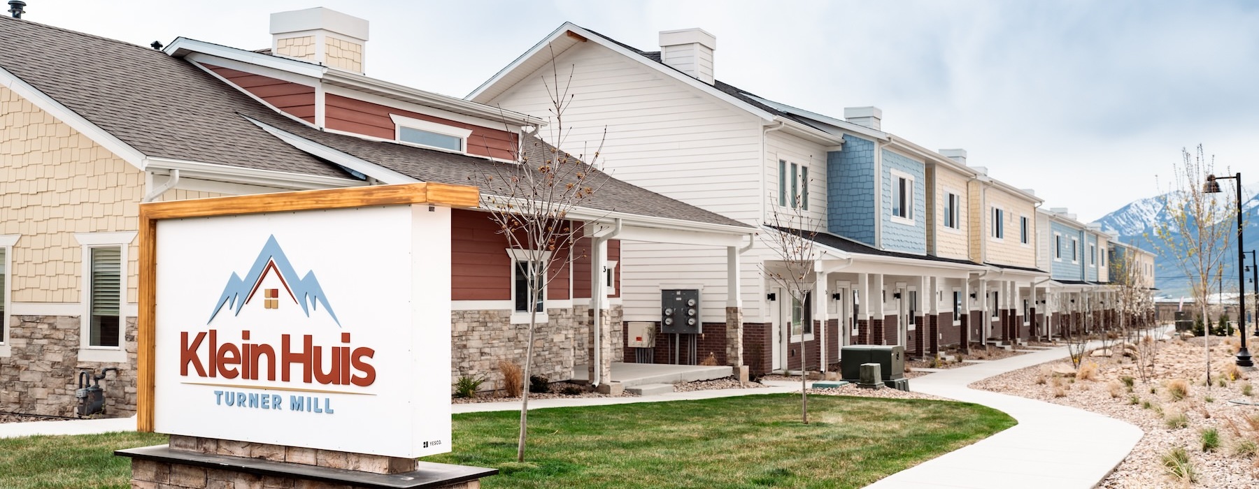 a row of houses with a sign in front
