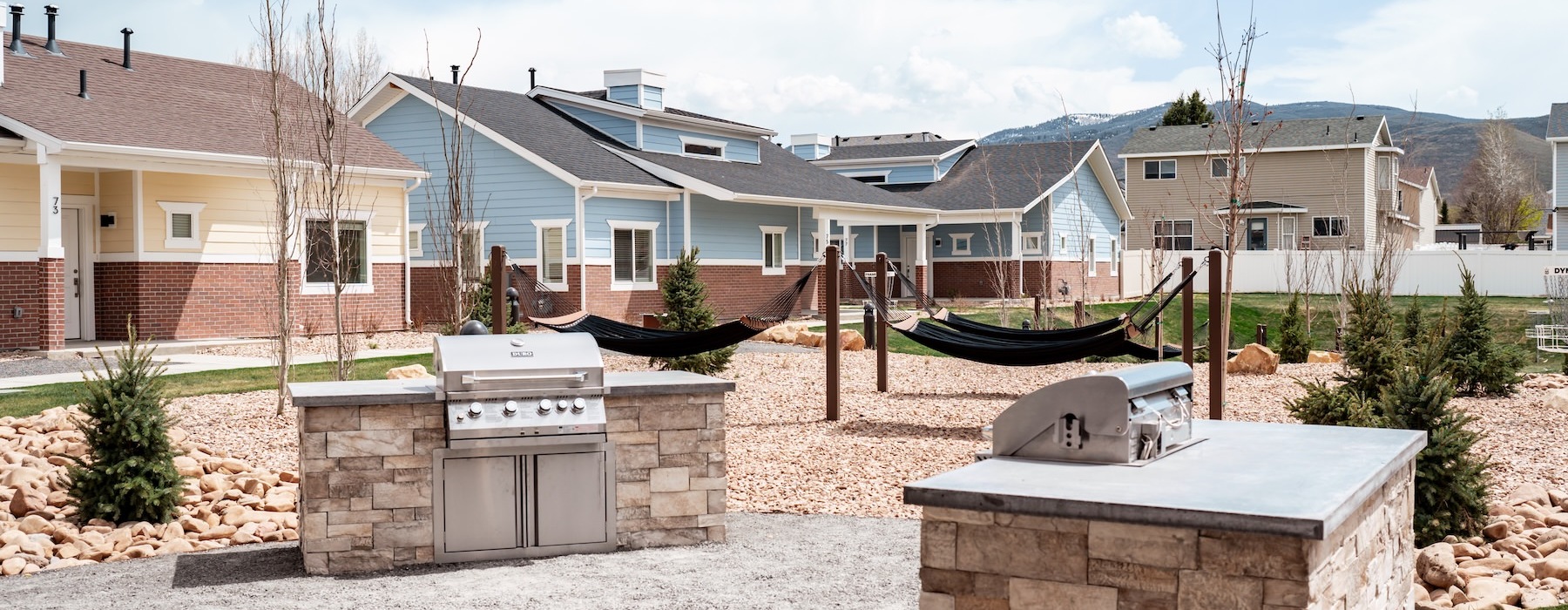 a grill area with buildings in the background