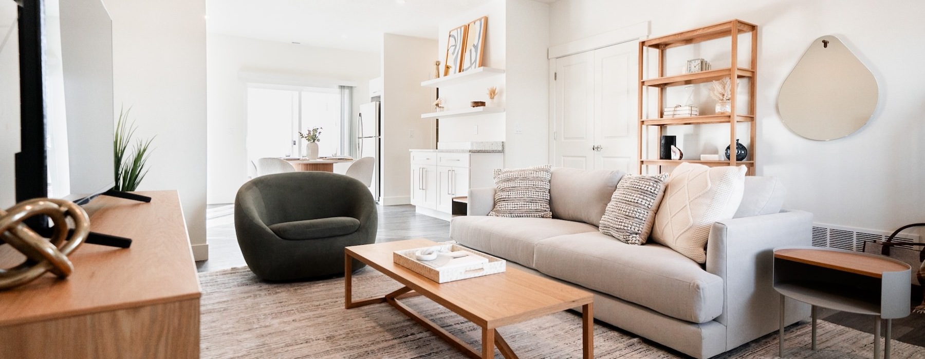 a living room with a couch, chair and tables